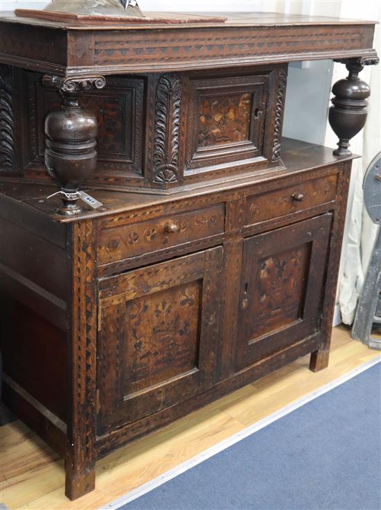 A 17th century marquetry inlaid oak court cabinet W.127cm